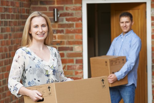 Professional movers handling office furniture and equipment