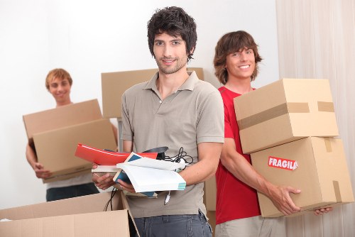 Local man with van handling boxes and household items in Barking