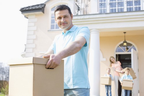 Professional movers carrying boxes in a Barking flat removal