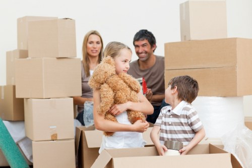 Local movers handling boxes and furniture near Barking flats
